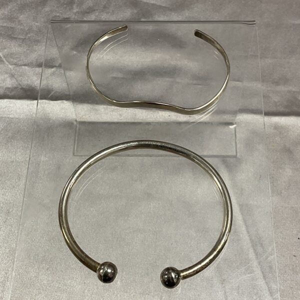 Pair of vintage 925 silver cuff bracelets with rounded ends.