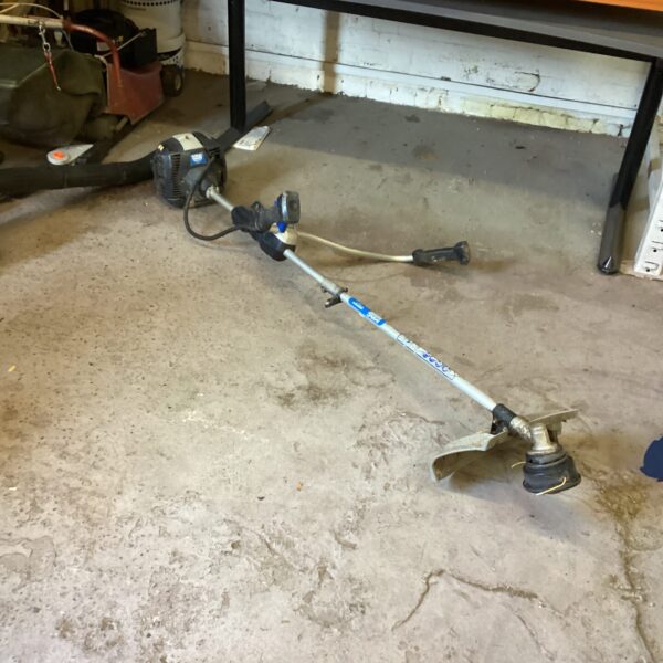 Used Mac Allister petrol strimmer for garden maintenance.