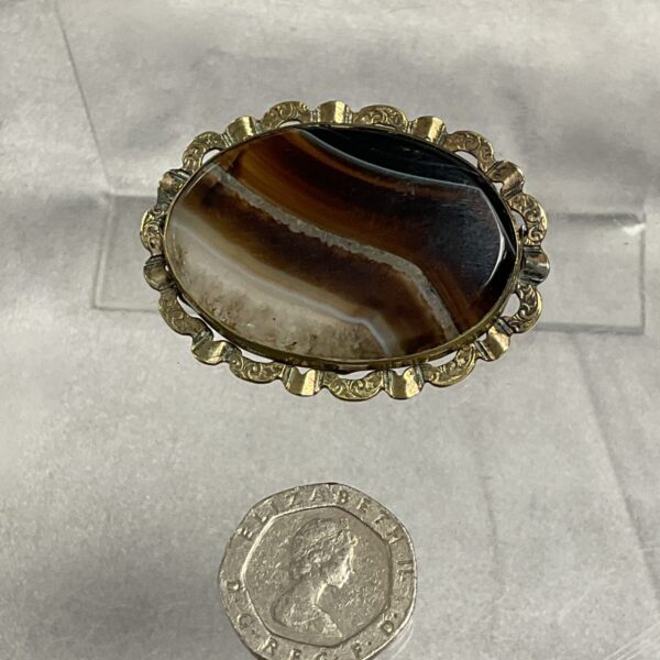 Antique banded agate brooch with yellow metal frame.