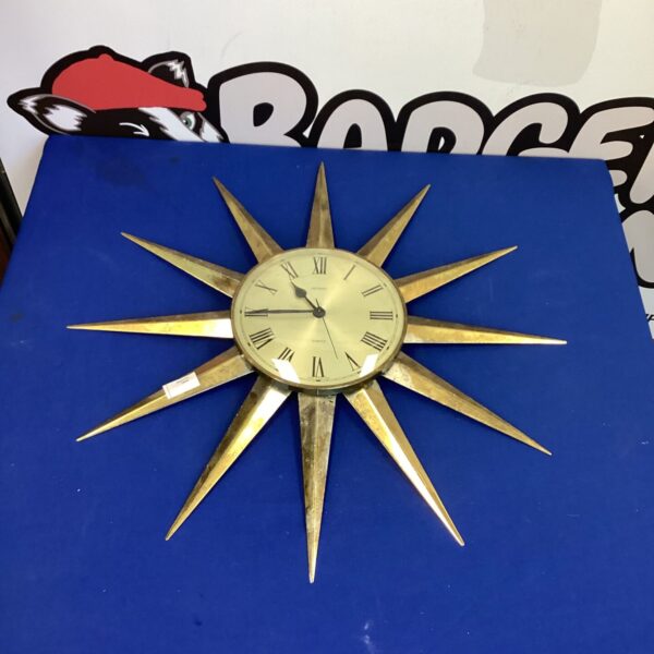 Vintage Metamec sunburst clock with bold hour markers.