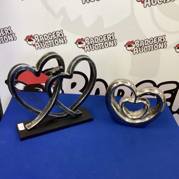 Pair of decorative metal heart sculptures in wrought iron.
