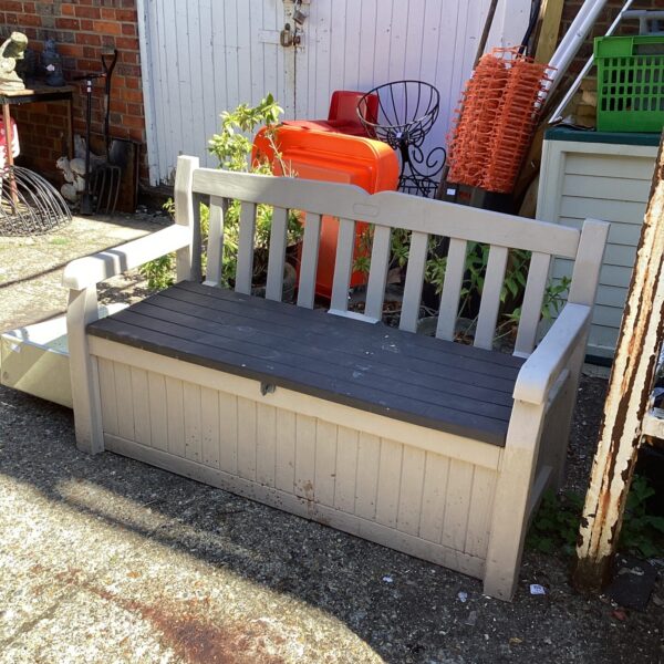 Keter plastic garden storage bench in a garden setting.