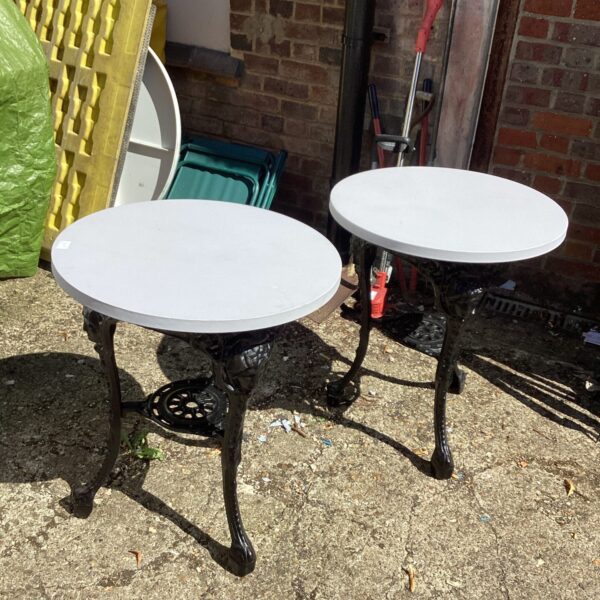 Pair of refurbished wrought iron garden tables for outdoor use.