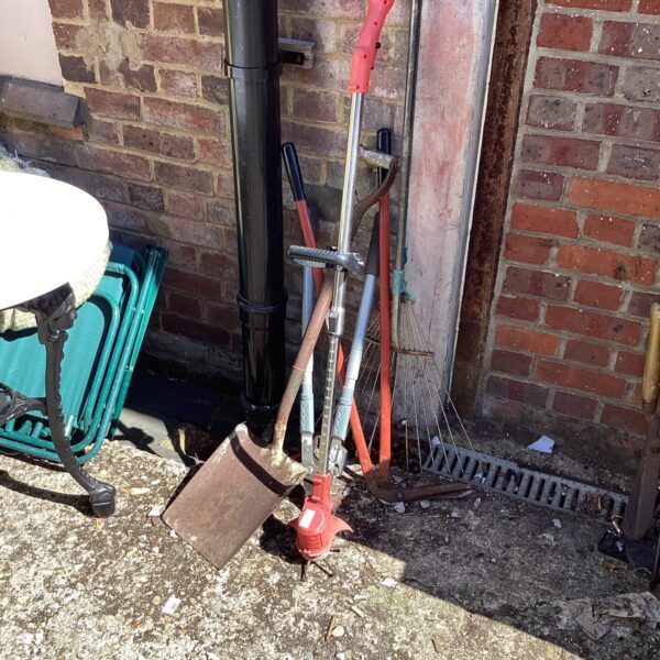 Selection of vintage garden tools including a spade and rake.