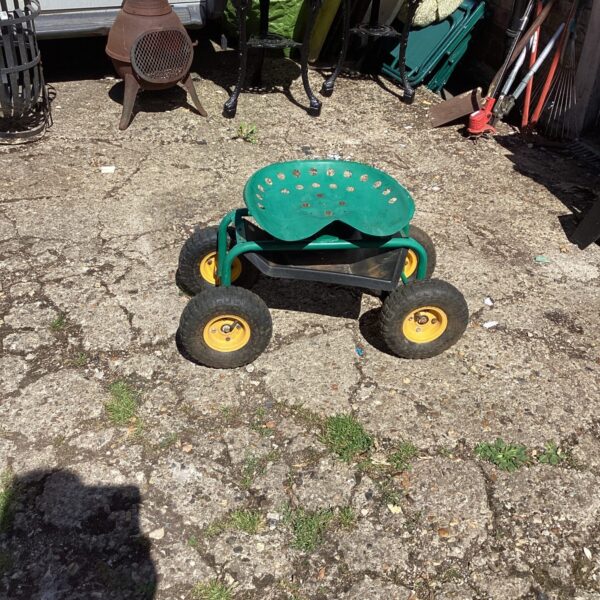 Green garden weeding cart with wheels and padded seat.