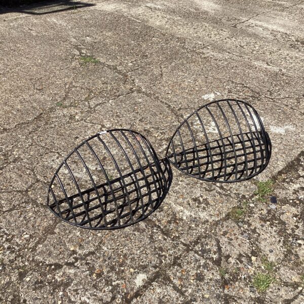 Pair of vintage metal wall planters for garden display.