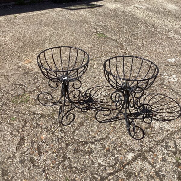 Pair of vintage metal garden plant stands for flower display.