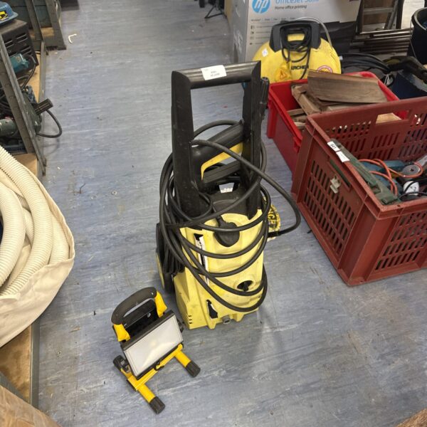Yellow and black Wilks rx150 pressure washer with Diall site light.