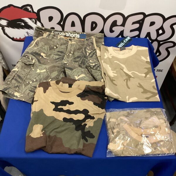Camo shorts and three new t-shirts in a clothing lot.