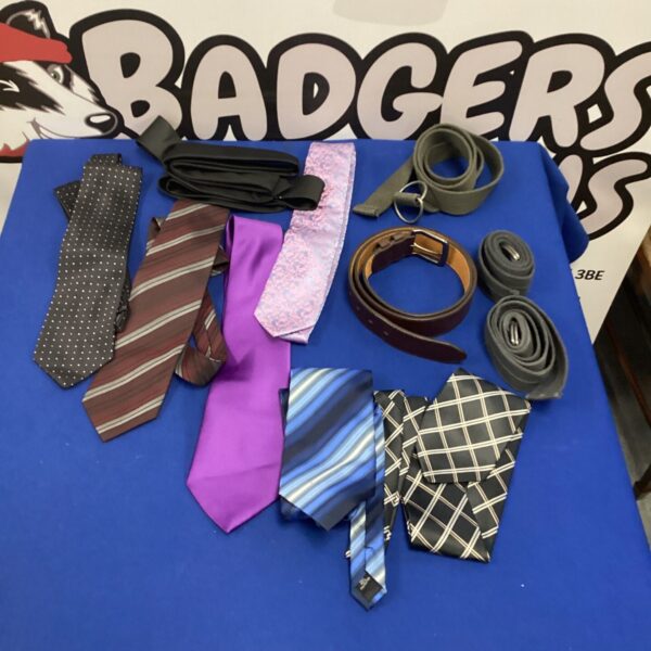 Assorted ties and belts in a mixed lot of men's fashion accessories.