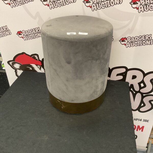 Modern grey fabric stool for home decor and seating.