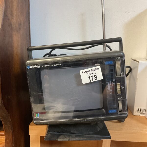 Vintage Roadstar portable colour TV with antenna.