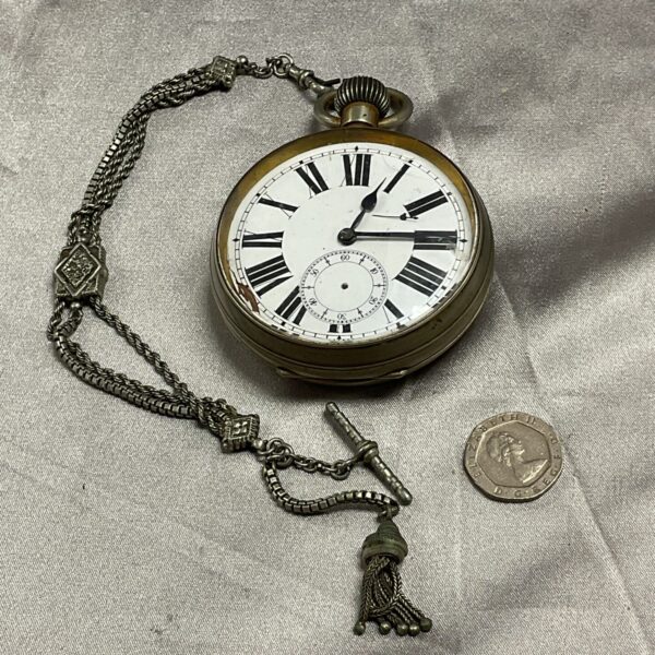 Vintage Goliath pocket watch with fob chain for restoration.