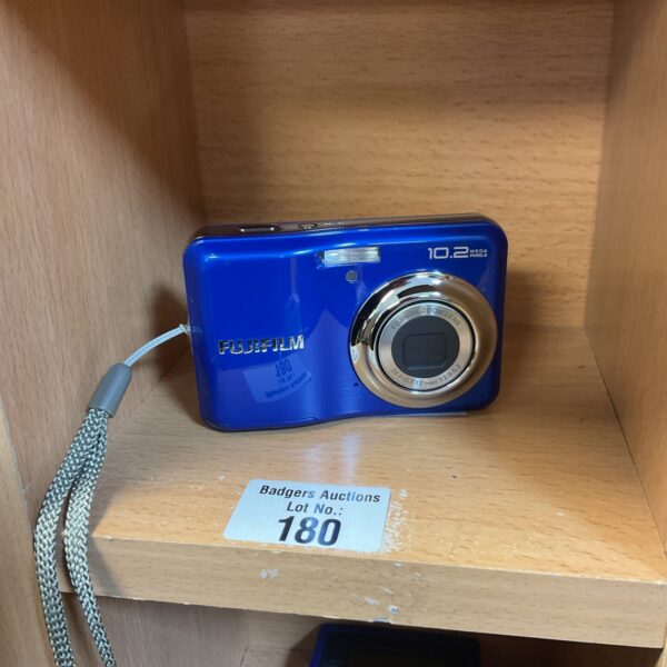 Blue Fujifilm digital camera with flash and lens.