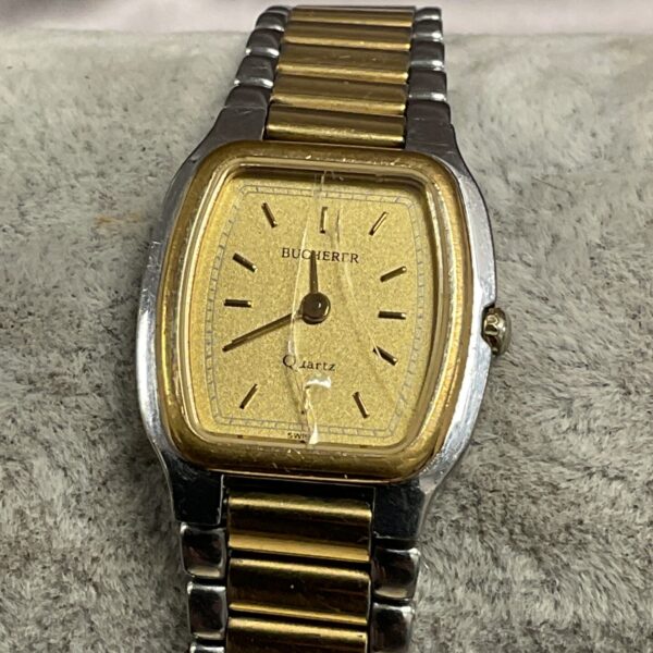 Vintage Bucherer ladies wristwatch with gold tone bracelet and yellow dial.