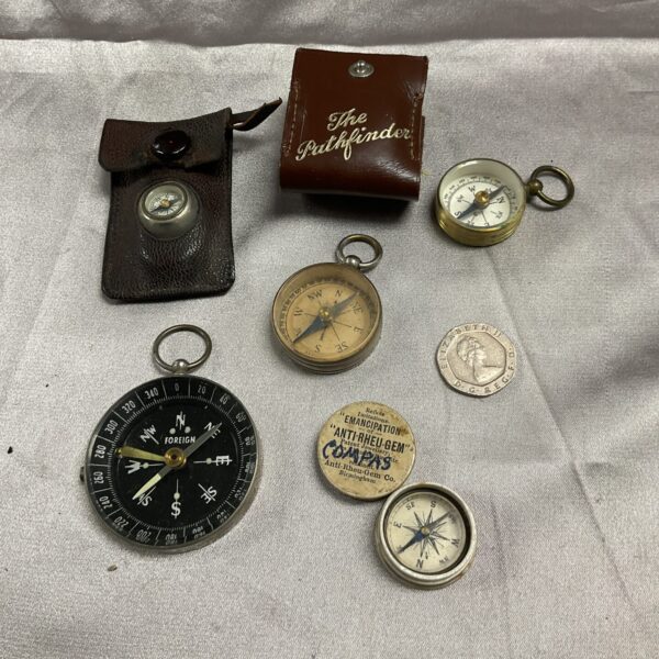 Lot of five vintage brass pocket compasses for navigation.