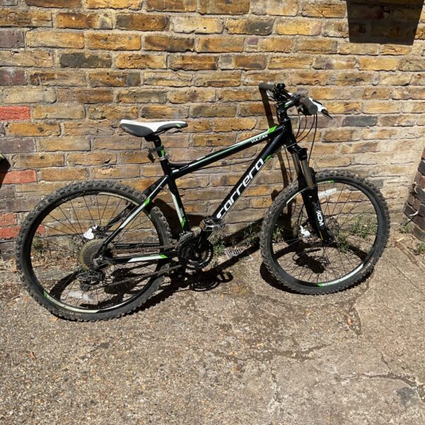 Silver and black Carrera Vulcan mountain bike in used condition.