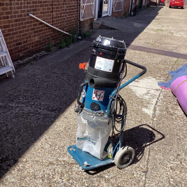 Portable exhaust ventilation system for dust extraction in a workshop.