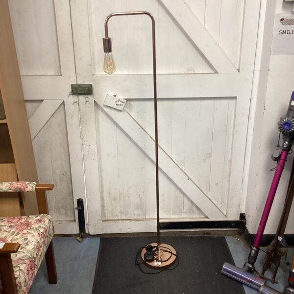 Rose gold standard lamp with a slender design.