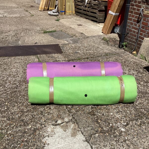 Two large roll-style camping mats for outdoor use.