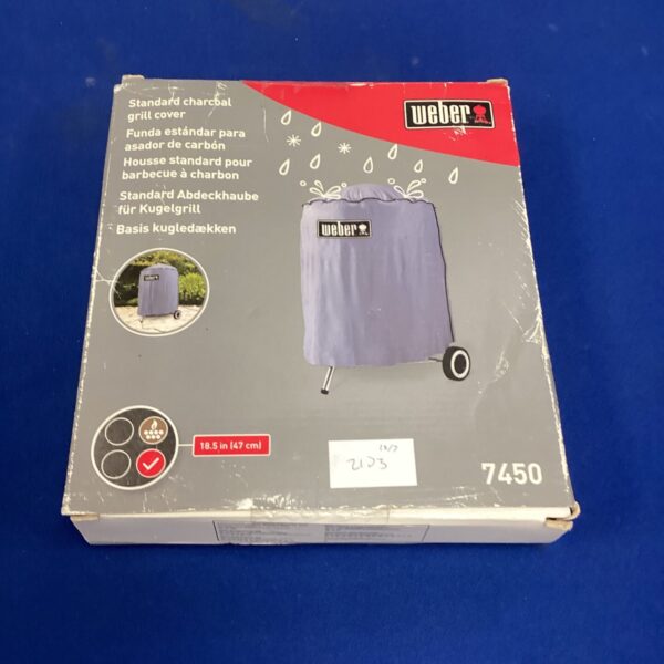 Used Weber 7450 charcoal grill cover for outdoor protection.