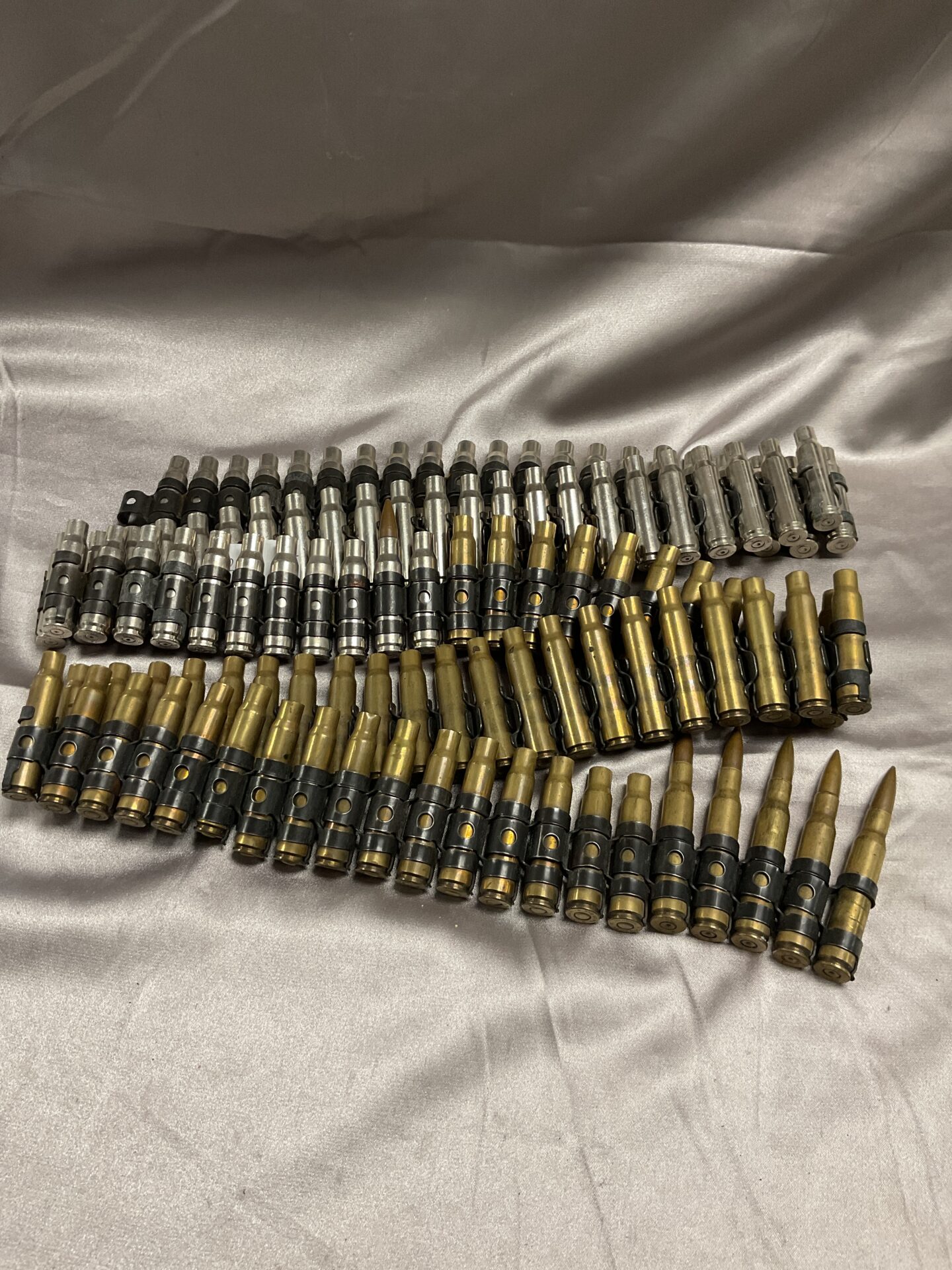 790 Approximately 5ft Belt of brass spent bullets