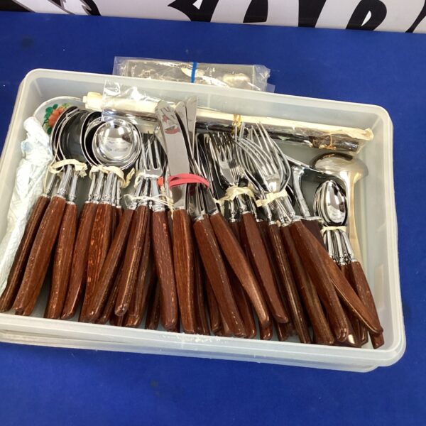 Vintage cutlery set with wooden handles and stainless steel blades.