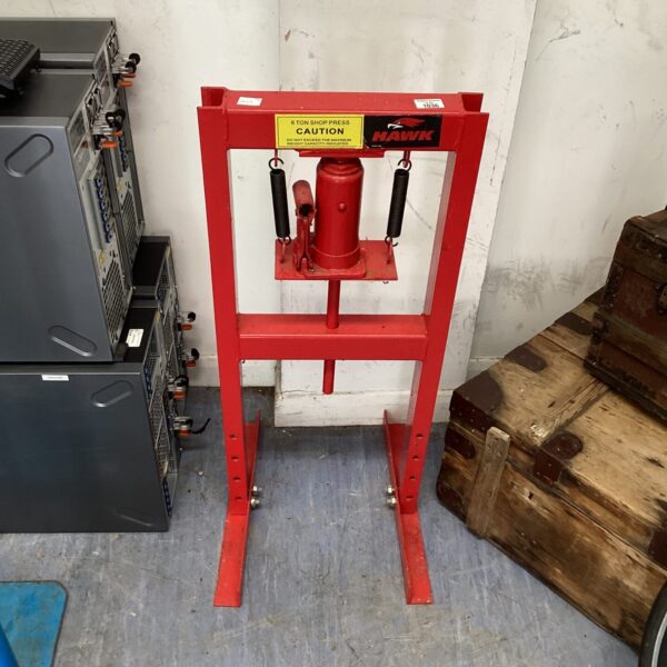 Red Hawk hydraulic shop press in a workshop setting.