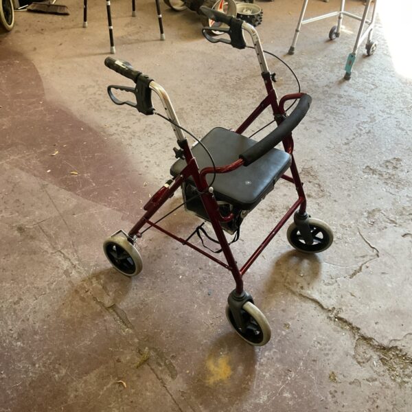 Front view of a Roma mobility walker with a padded seat.