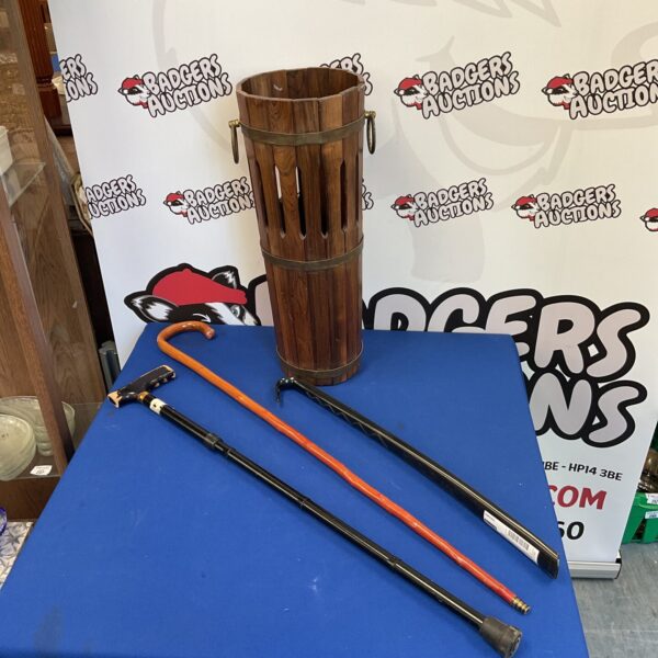 Vintage wooden walking stick stand with included walking sticks.
