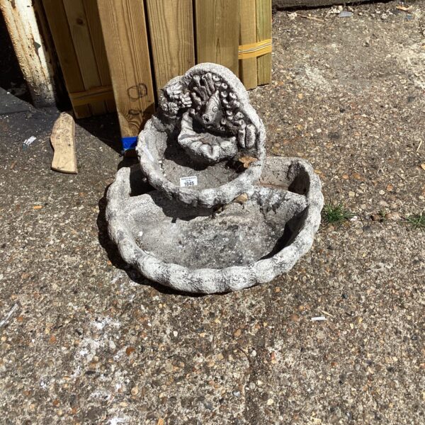 Tiered garden water feature with stone effect finish in outdoor setting.