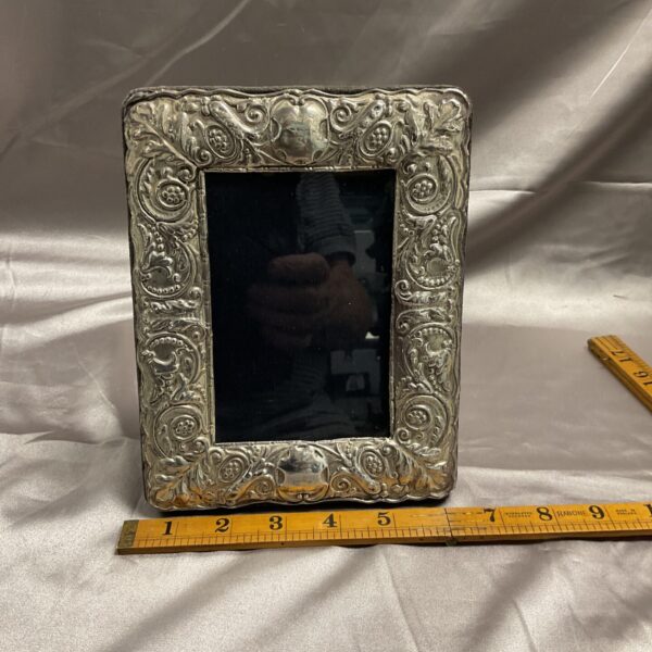 Ornate antique silver photo frame displaying a photograph.