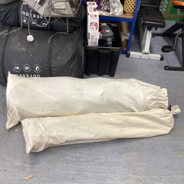 Rolled large camping tent with poles, ready for outdoor adventures.