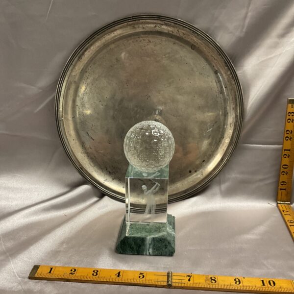 Vintage silverplate tray and golf trophy on display.