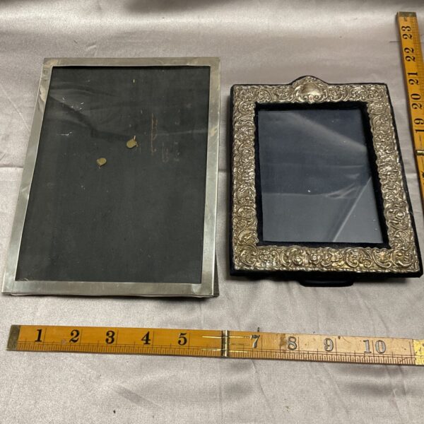 Ornate vintage silver photo frame with detailed design.