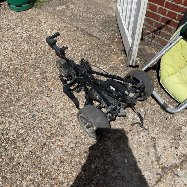 Used Powakaddy electric golf trolley, side view.