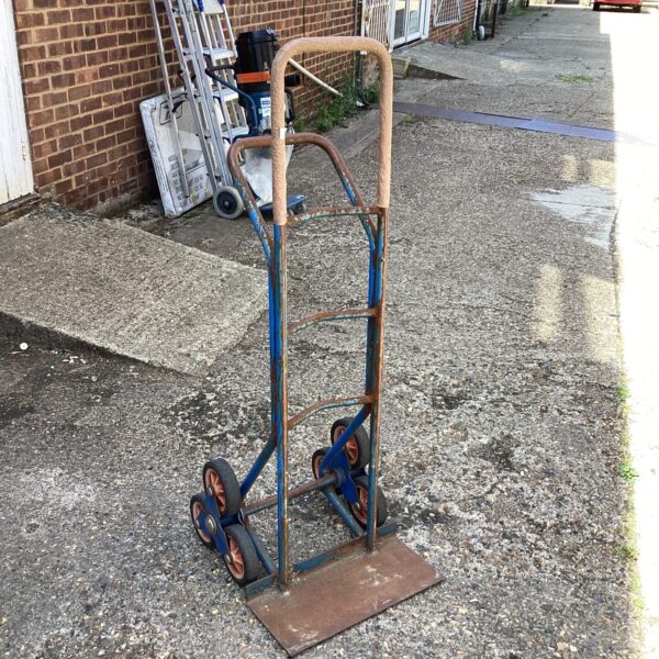 Heavy-duty metal sack barrow with wheels for industrial use.