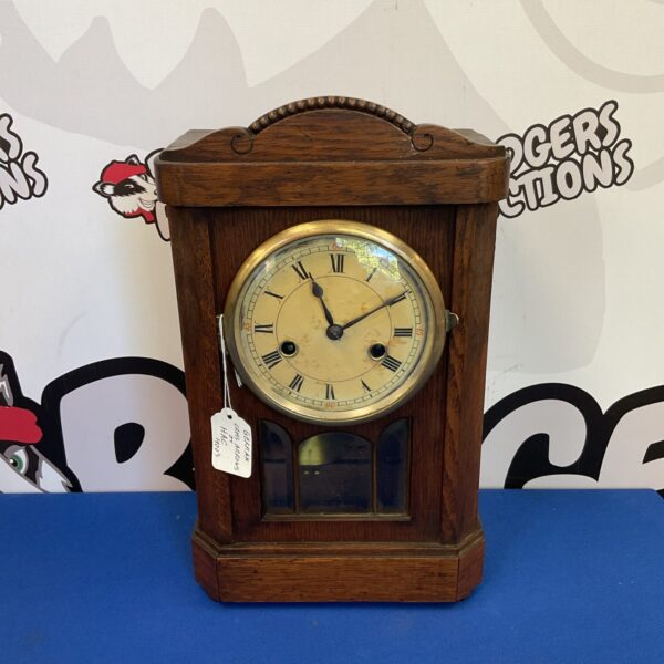 Antique German mantle clock with Roman numeral dial.
