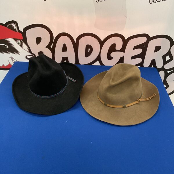Black and brown vintage cowboy hats on a blue background.