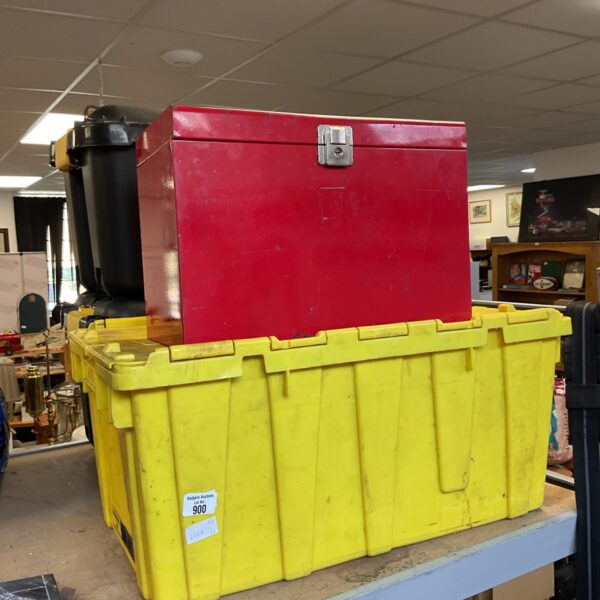 Yellow plastic storage crate with red metal toolbox on top.