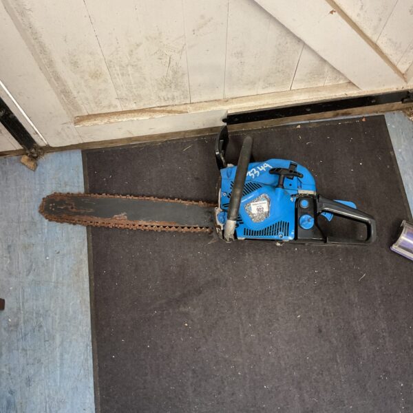 Side view of a used SGS petrol chainsaw for garden work.