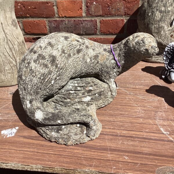 Detailed stone garden otter statue for outdoor decoration.