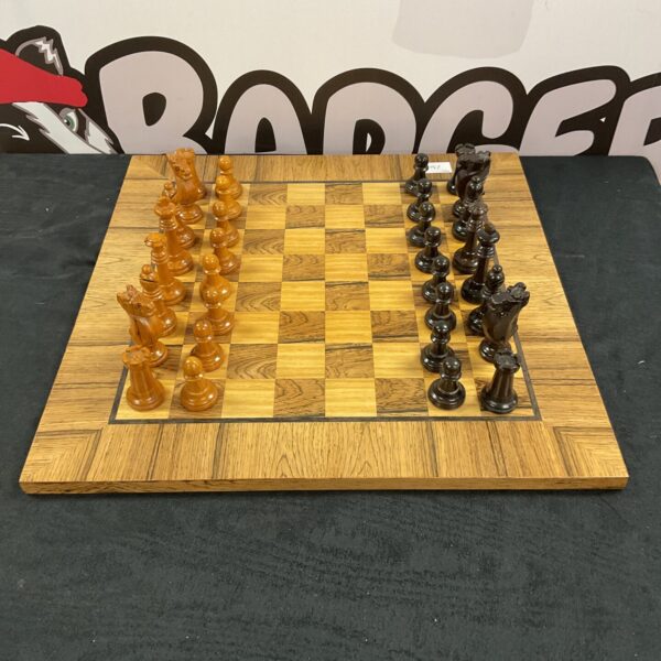 Handmade wooden chess set with carved pieces on a polished board.