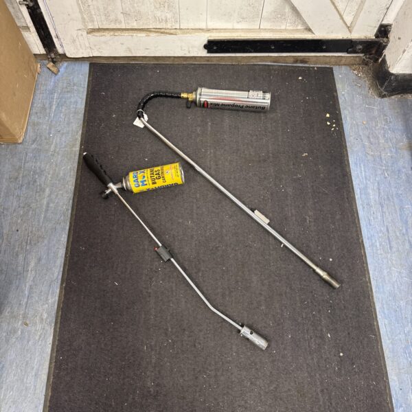Two used butane torches, ideal for weed control in the garden.