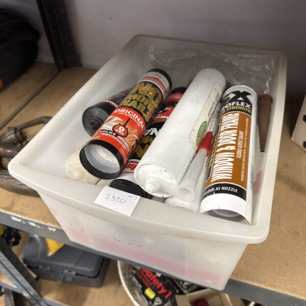 Assorted adhesive and sealant tubes for DIY projects.