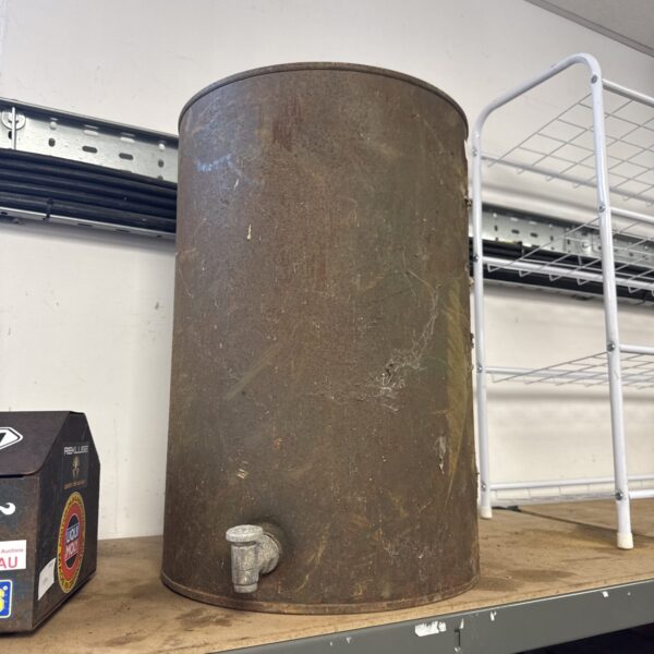 Weathered vintage metal water tank for rustic industrial decor.