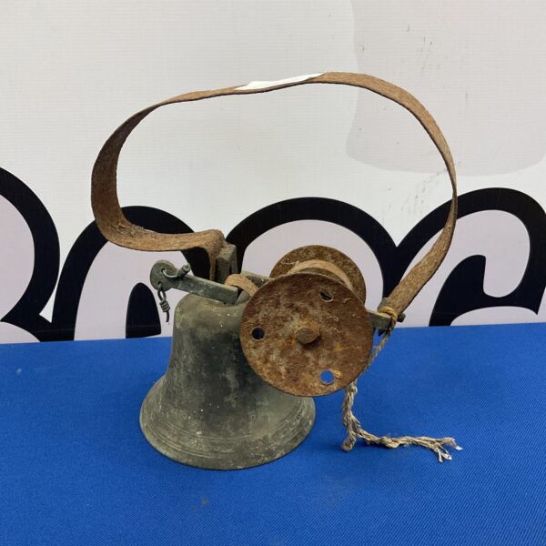 Antique Victorian brass shop door bell with looped handle.