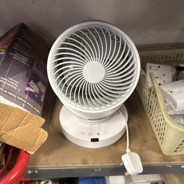 Vintage oscillating desk fan on a tabletop.
