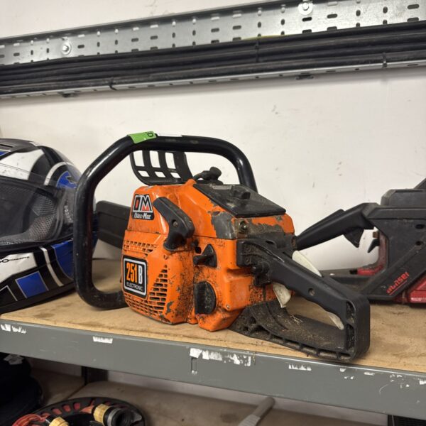 Front view of an Oleo Mac petrol chainsaw for garden use.