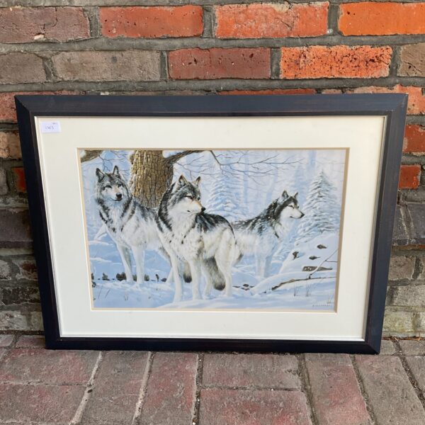 Framed wolf pack print by A Fernandez in a winter scene.